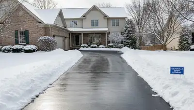 Clean driveway after professional snow removal by Chop Chop Landscaping in Naperville, IL